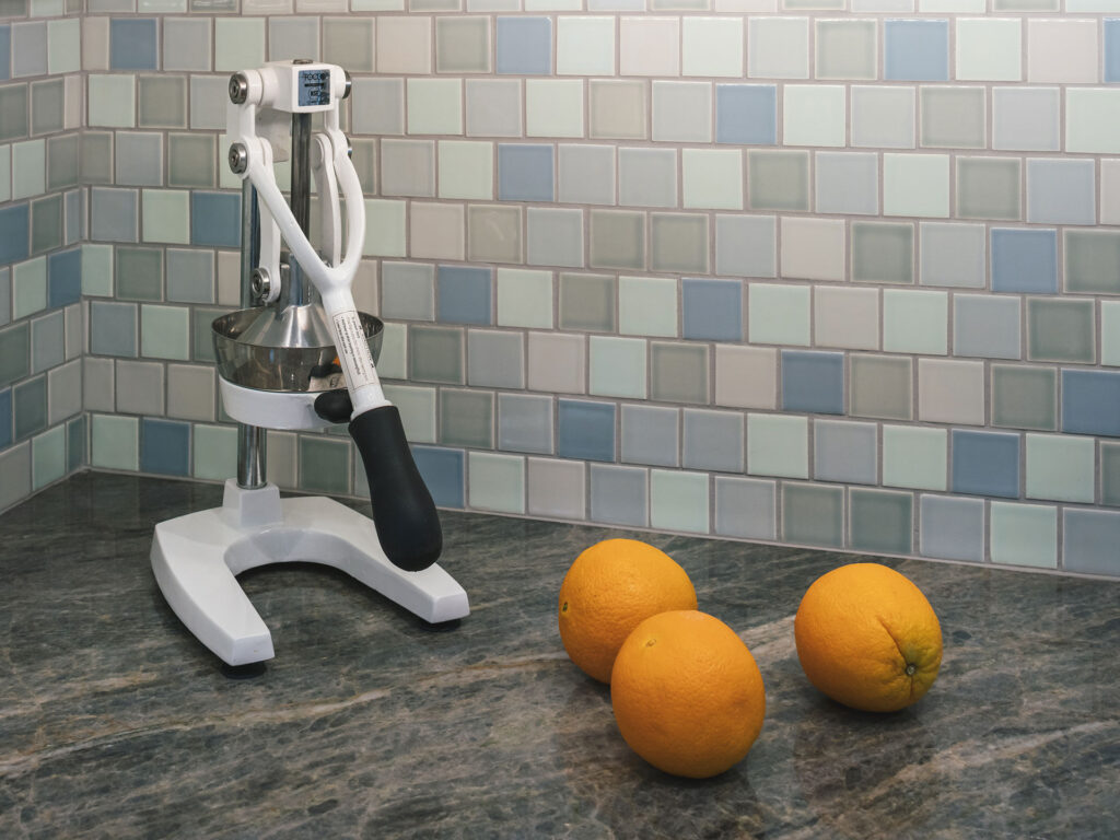 A custom blend of colorful tile for a kitchen backsplash in blues and greens.