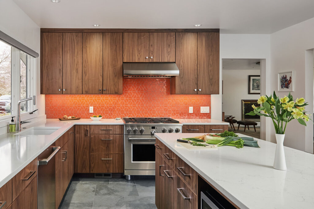 A bright red-orange colorful tile in a split hexagon pattern for a kitchen backsplash.
