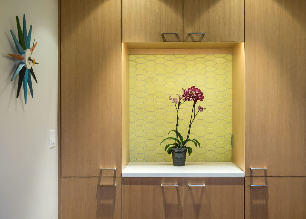 A unique yellow colorful tile in a smooshed hexagon pattern for a kitchen backsplash.