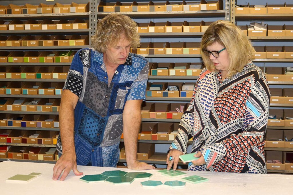 Jason and Megan Coleman discuss green tile colors in the Clayhaus facility.