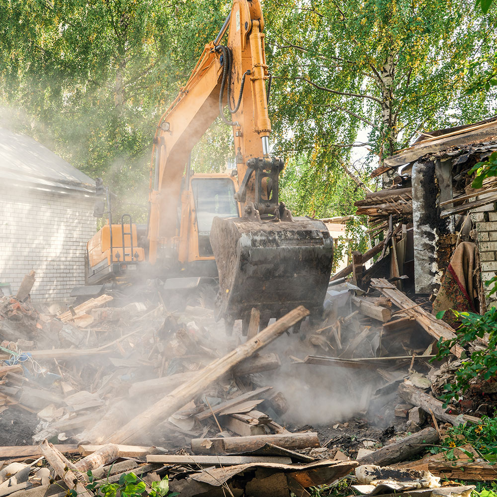 Bulldozer demolishes a house but must wait 35 days for the residential demolition delay in Portland.