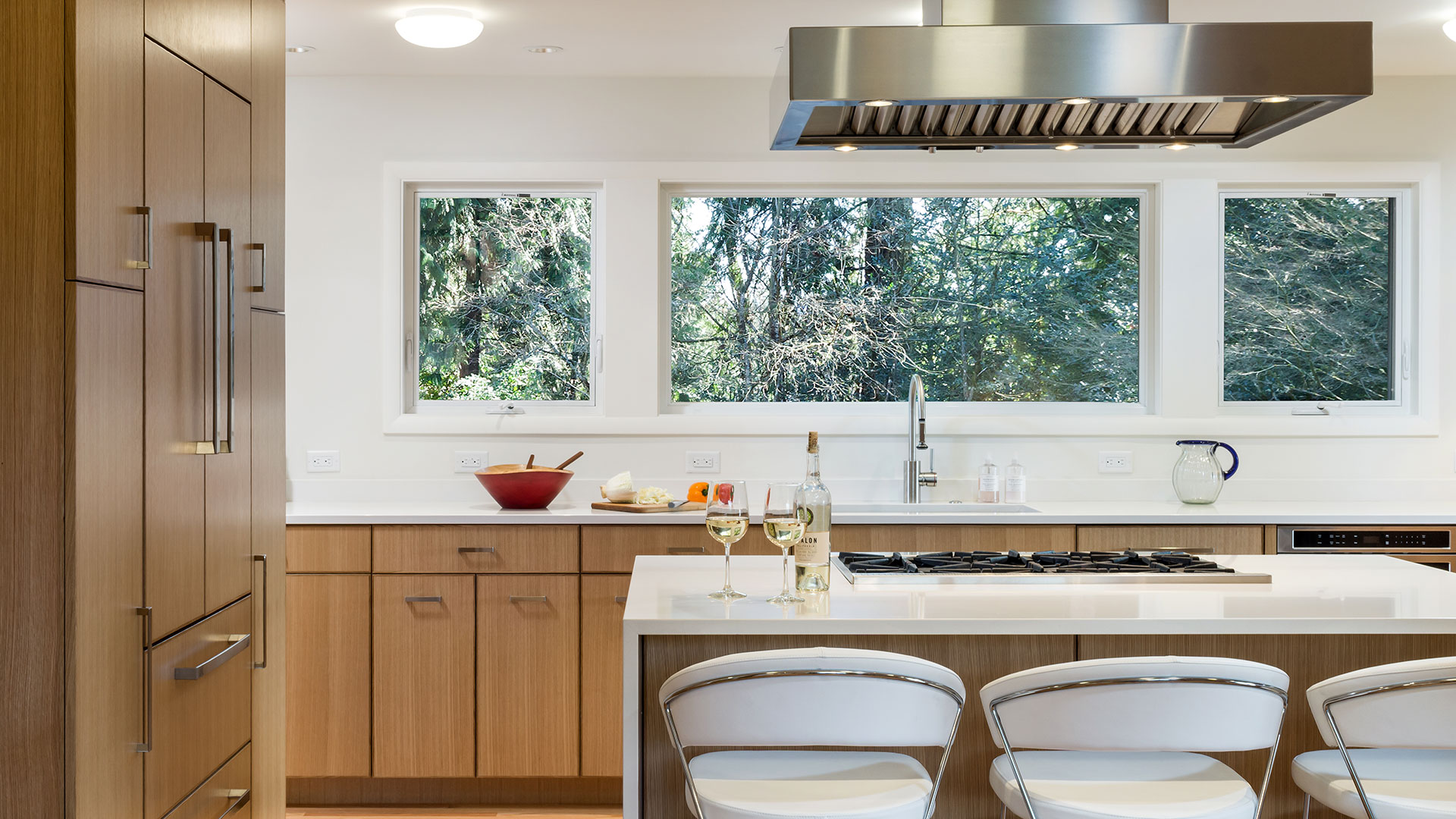 This entertainer's kitchen has a view of the tree-filled back yard.