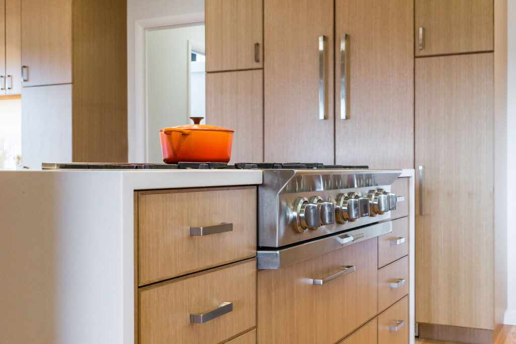 This entertainer's kitchen features a built-in, panel-front fridge and freezer.