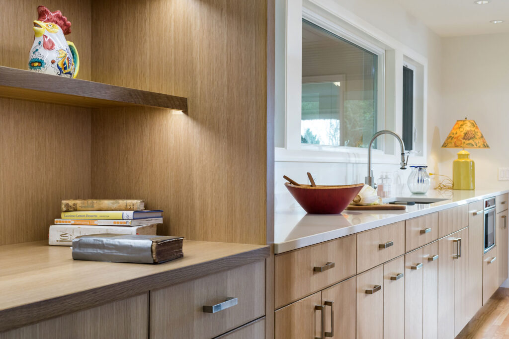 The cookbook shelving is lit with LED tape light in this entertainer's kitchen.
