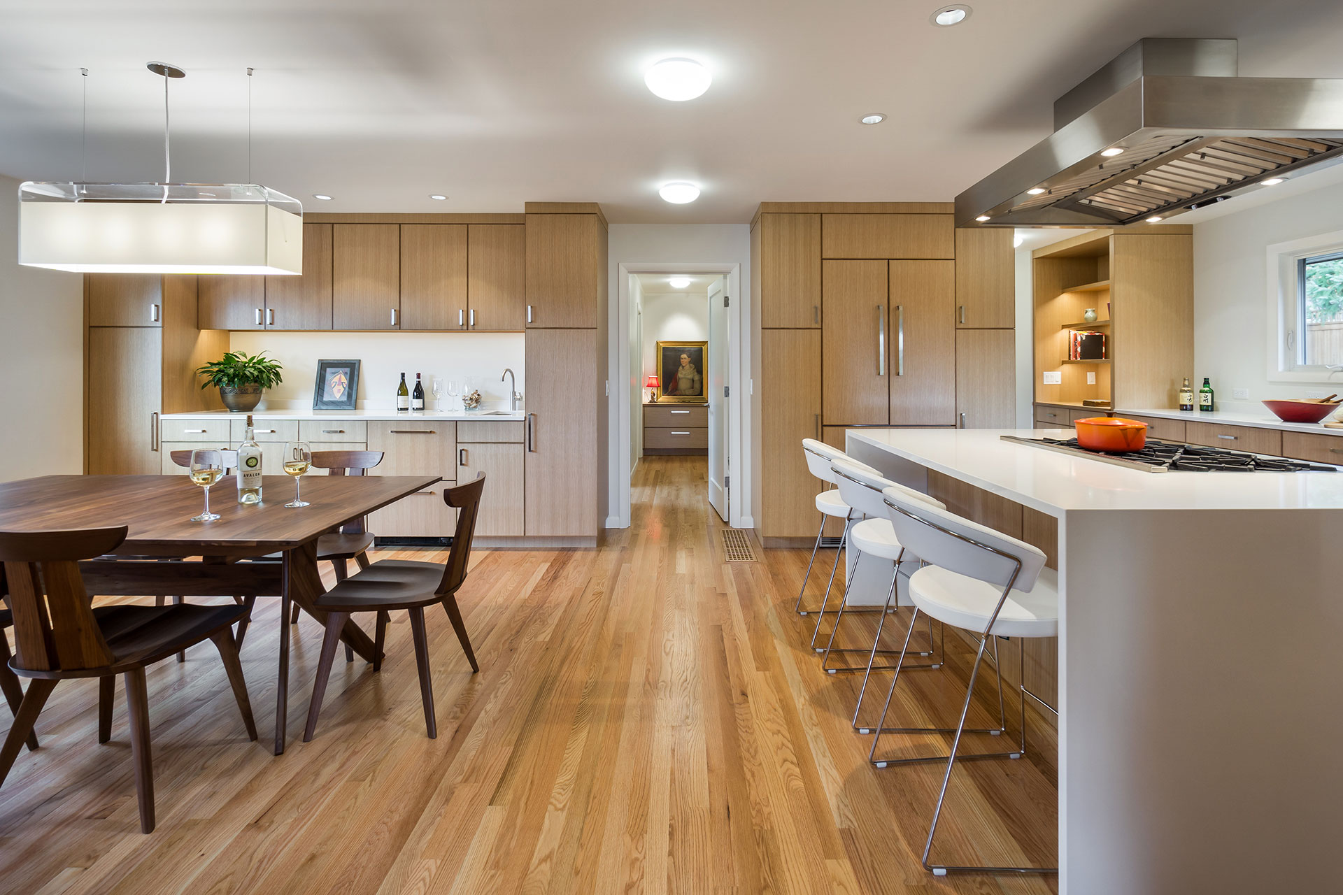 This entertainer's kitchen is divided into dining and cooking zones that are separated by a large island.