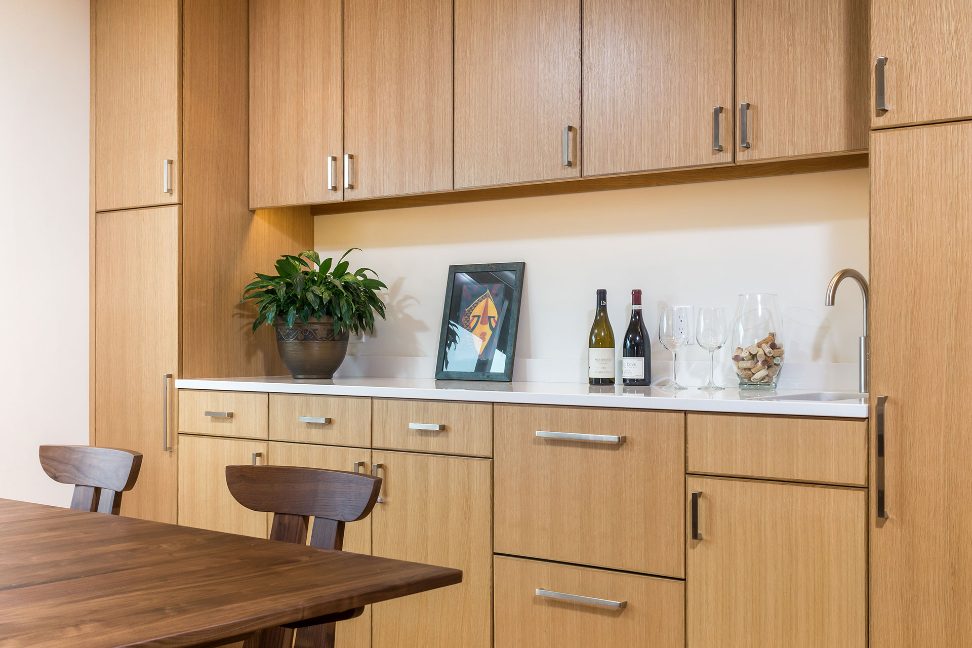 This entertainer's kitchen features a bar with sink and built-in fridge and freezer drawers.