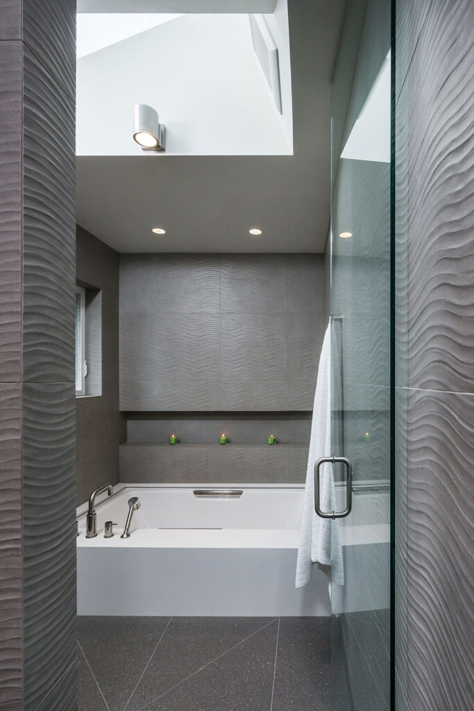 The primary bathroom has a walk-in shower with partially recessed soaking tub.