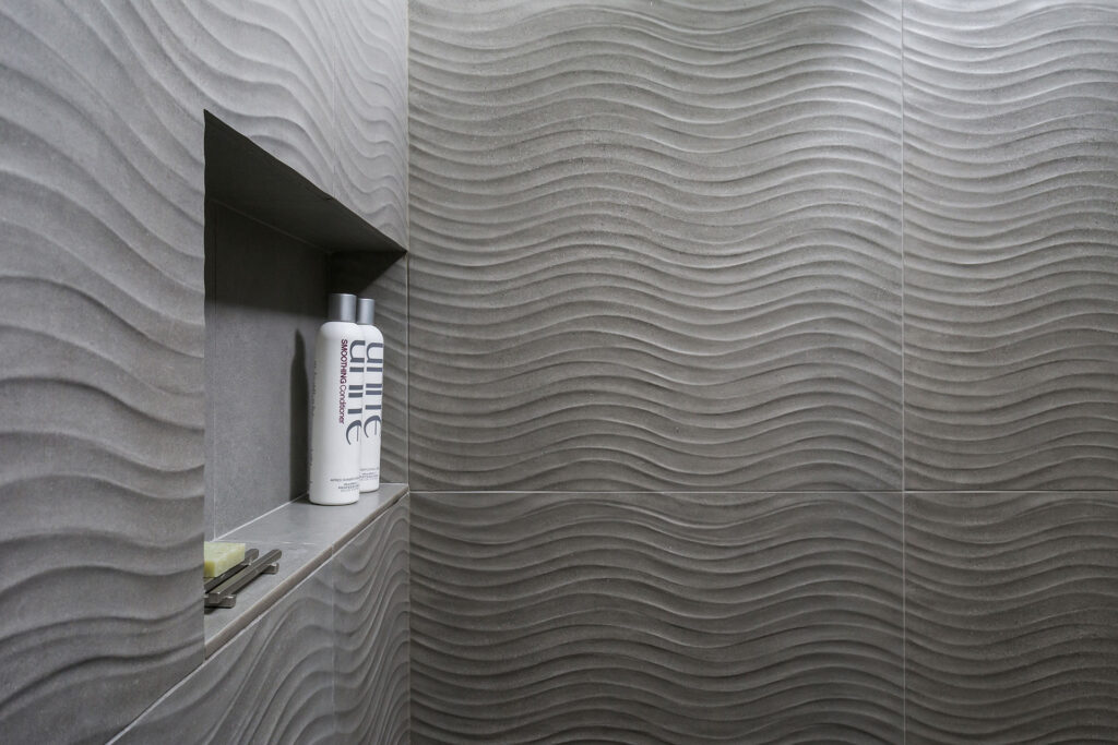 A shampoo niche is built into the walls of the primary bathroom shower.