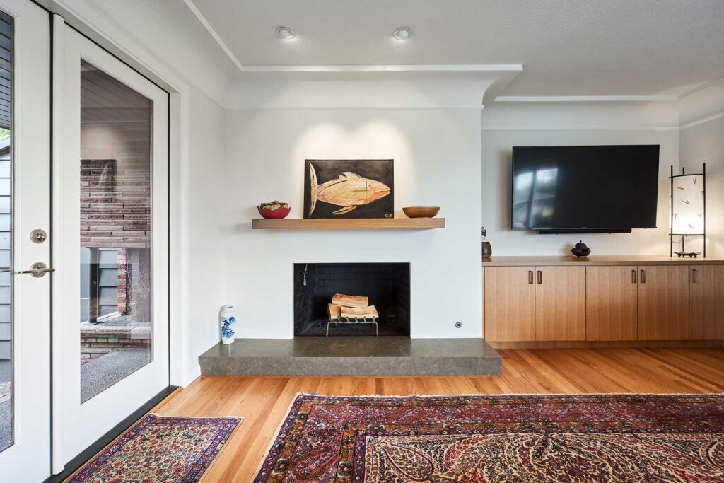 Living room with cove moulding, fireplace with oak mantle and limestone hearth.