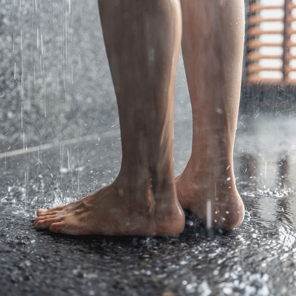 Bare feet on a heated bathroom floor.