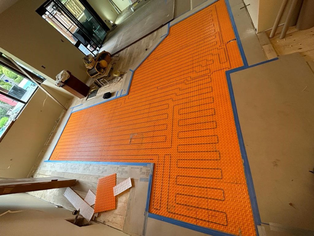 Electric cable heat system in custom inlayed tile floor.