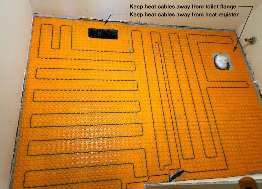 Heated bathroom floor showing clearances around heat register and toilet flange.