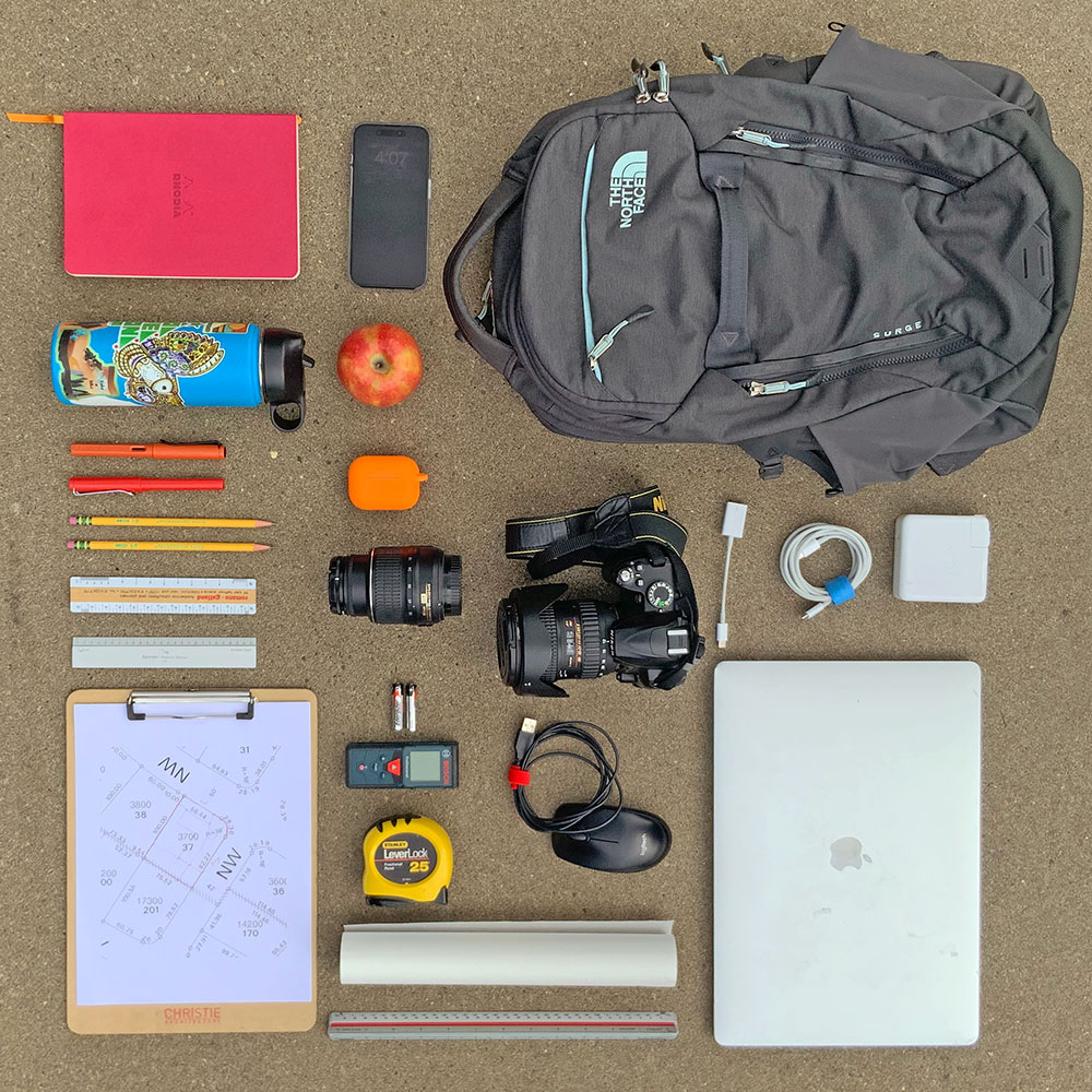 The tools used for measured drawings include a notebook, a water bottle, pends, pencils, measuring scales, a clipboard, a phone, AirPods, a camera, a laser measurer, a tape measure, tracing paper, a laptop, a mouse, and a backpack.
