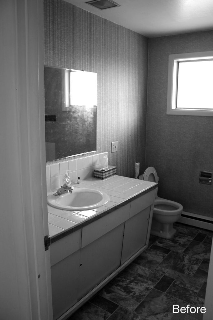 Before bathroom with outdated tile countertop, small sink, textured wallcovering, and limited storage in a cramped layout.