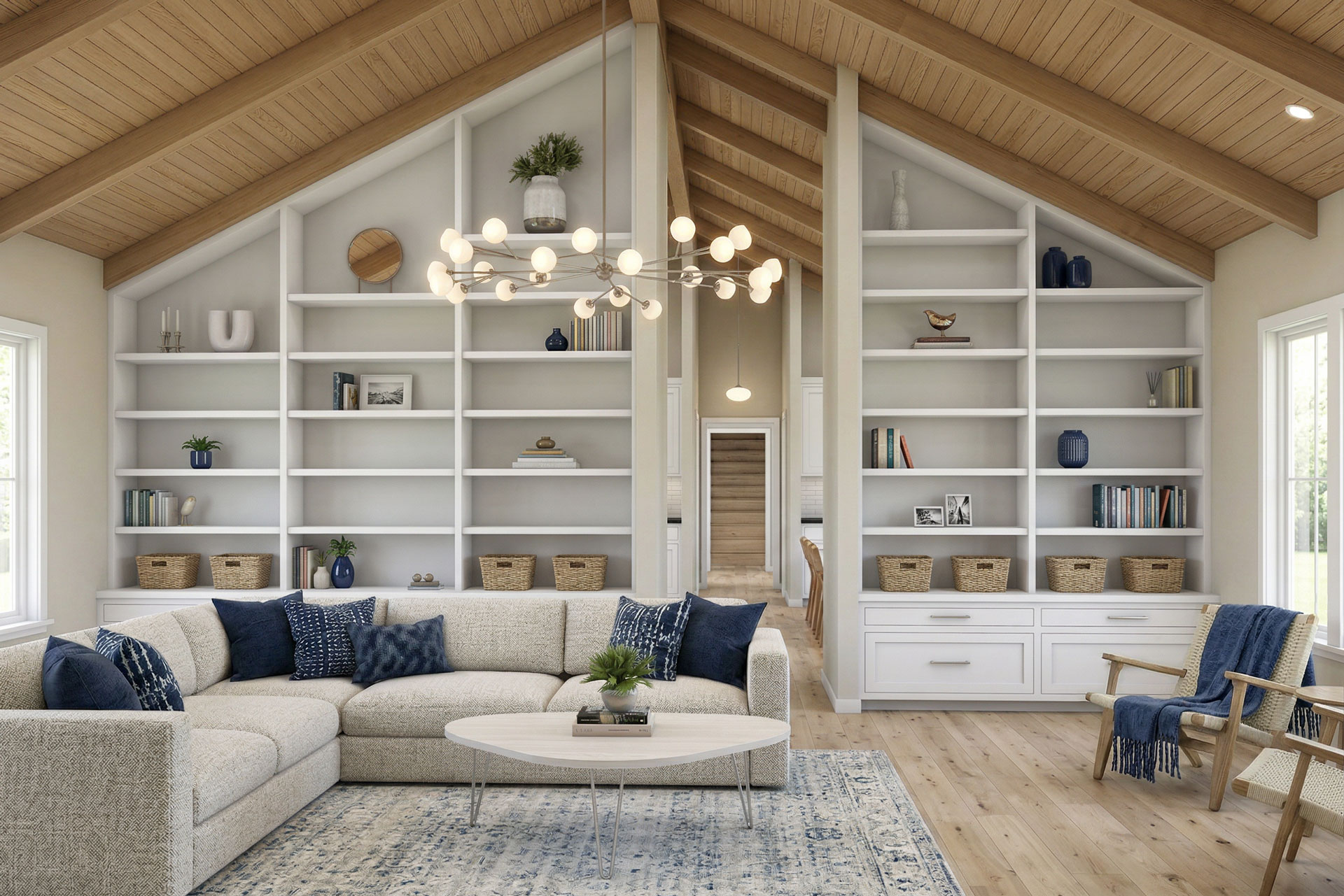 Bright living room with vaulted wood ceiling, built-in white shelving, and a large sectional sofa centered around a round coffee table and modern chandelier.