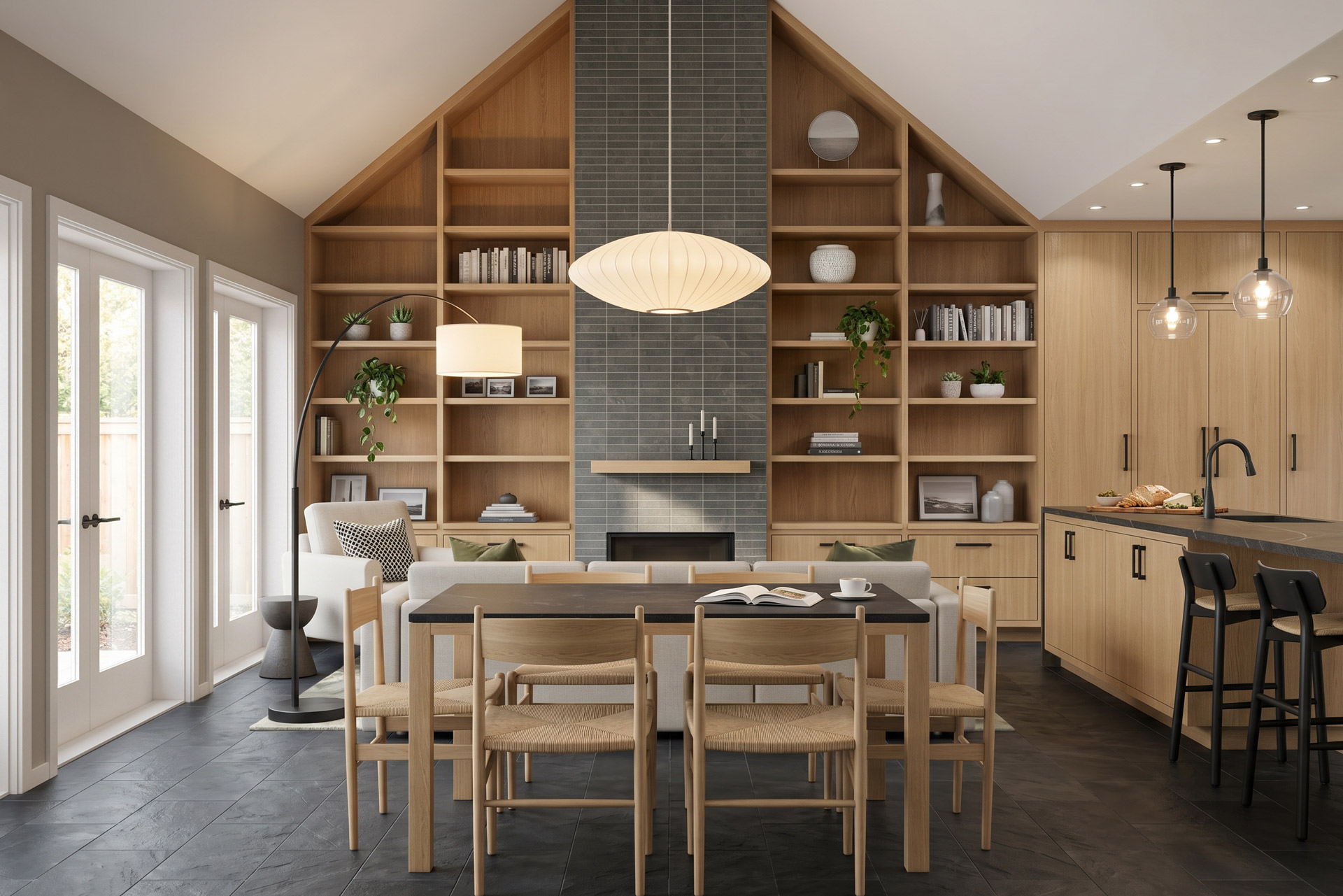 Open-plan dining and living area with vaulted ceiling, light wood built-in shelving, central tiled fireplace, French doors, and adjacent kitchen.