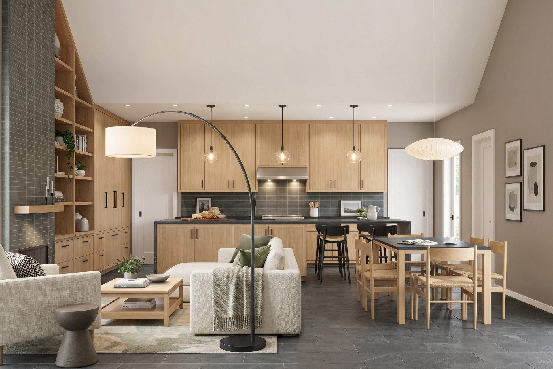 Open-plan living, dining, and kitchen interior with light wood cabinetry and built-ins, dark tile flooring, vaulted ceiling, and neutral furnishings.